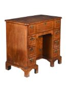 A GEORGE II FIGURED WALNUT AND FEATHER-BANDED KNEEHOLE DESK