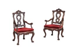 A PAIR OF IBERIAN CARVED WALNUT OPEN ARMCHAIRS IN 18TH CENTURY STYLE
