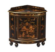 A BLACK LACQUER AND GILT DECORATED CORNER CABINET
