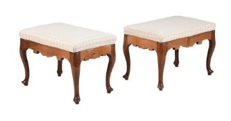 A PAIR OF CONTINENTAL WALNUT AND UPHOLSTERED STOOLS