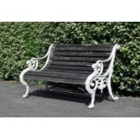 A WHITE PAINTED CAST IRON GARDEN BENCH