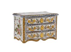 A DEVRES FAIENCE (GABRIEL FOURMAINTRAUX) MODEL OF A COMMODE OF THREE LONG DRAWERS