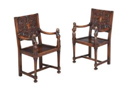 A PAIR OF CONTINENTAL CARVED WALNUT OPEN ARMCHAIRS