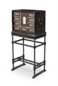 Y AN EBONY AND EBONISED, IVORY MARQUETRY INLAID CABINET ON STAND