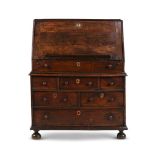 A QUEEN ANNE OAK BUREAU, CIRCA 1710