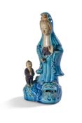 A CHINESE TURQUOISE AND AUBERGINE MODEL OF GUANYIN 19TH CENTURY OR EARLY 20TH CENTURYWith boy a