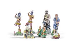 A GROUP OF EIGHT CHINESE-EXPORT UNDERGLAZE PAINTED BUDDHISTIC FIGURES, VARIOUS DATES