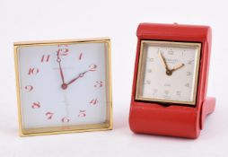 TIFFANY & CO., A GILT METAL AND RED LEATHER TRAVEL ALARM 8 DAY DESK CLOCK