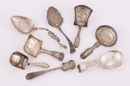 A COLLECTION OF SILVER CADDY SPOONS