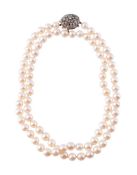 A CULTURED PEARL NECKLACE TO A DIAMOND ACCENTED FLOWER HEAD CLASP