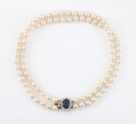 A TWO ROW CULTURED PEARL NECKLACE WITH A SAPPHIRE AND DIAMOND CLASP, LONDON 1990