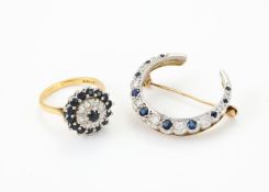 A SAPPHIRE AND DIAMOND CLUSTER RING AND CRESCENT BROOCH