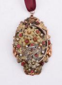 A LATE 19TH/EARLY 20TH CENTURY SILVER GILT SYNTHETIC RUBY AND HALF SEED PEARL BIRD LOCKET PENDANT