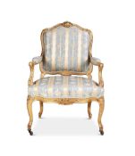 A CARVED GILTWOOD AND UPHOLSTERED FAUTEUIL IN LOUIS XV STYLE, CIRCA 1860