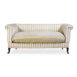AN EDWARDIAN MAHOGANY AND UPHOLSTERED SOFA IN THE MANNER OF HOWARD & SONS