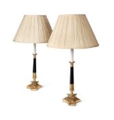 A PAIR OF EBONISED AND GILT METAL LAMP BASES, 20TH CENTURY IN THE EMPIRE MANNER