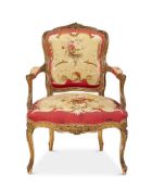 A FRENCH GILTWOOD AND TAPESTRY UPHOLSTERED FAUTEUIL IN LOUIS XV STYLE