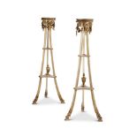 A PAIR OF GEORGE III CREAM PAINTED AND PARCEL GILT TRIPOD TORCHERES BY GILLOWS