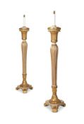 A MATCHED PAIR OF CREAM PAINTED AND PARCEL GILT TORCHERES ONE CIRCA 1780