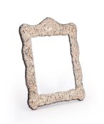 A SILVER MOUNTED SHAPED RECTANGULAR MIRROR