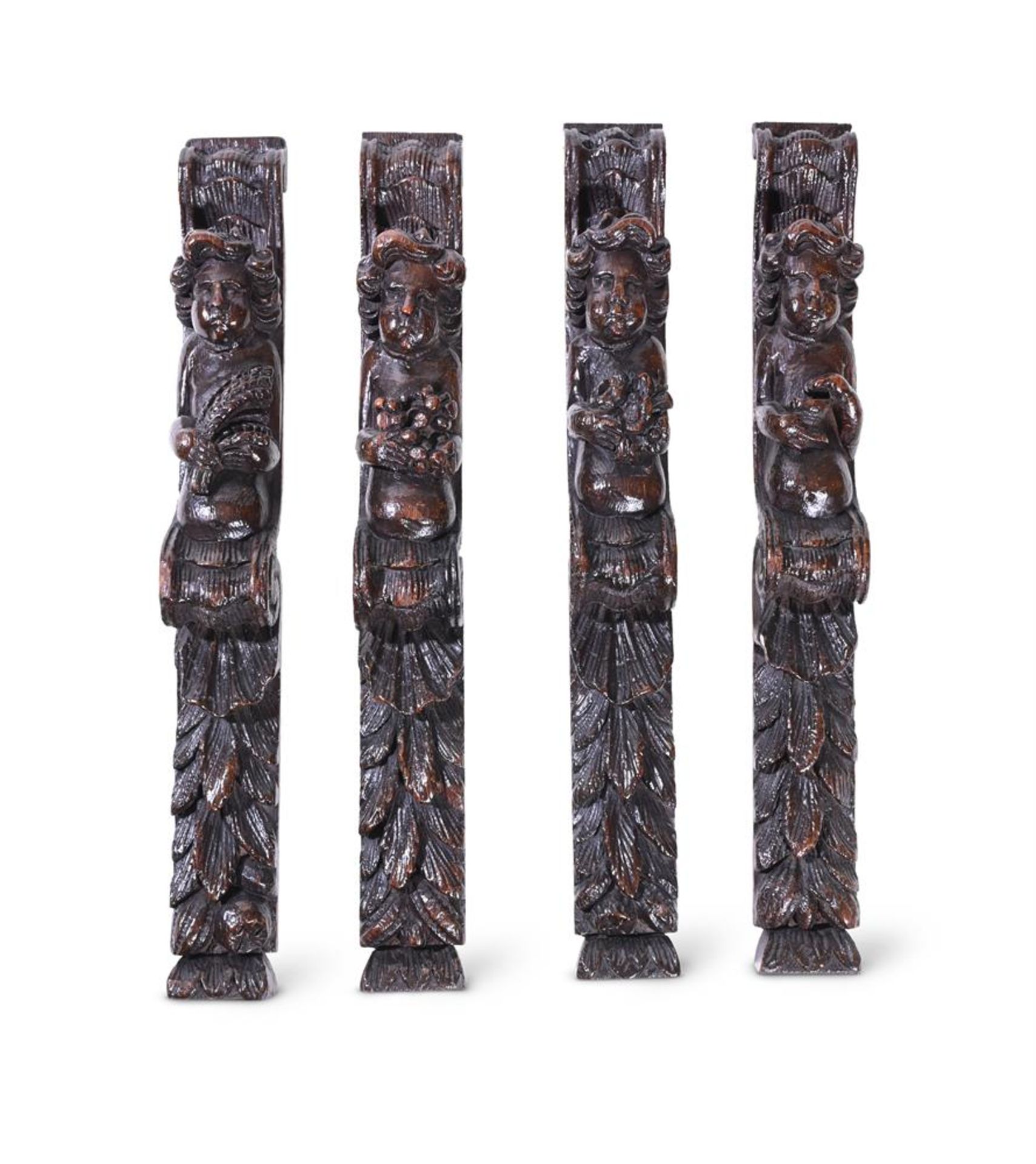 A SET OF FOUR CARVED OAK FURNITURE MOUNTS, LATE 17TH CENTURY