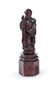 A CARVED OAK FIGURE OF A BISHOP SAINT, EARLY 17TH CENTURY