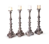 A SET OF FOUR ITALIAN SILVERED WOOD ALTAR CANDLESTICKS, LATE 18TH OR EARLY 19TH CENTURY