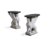 A PAIR OF CARVED WHITE MARBLE AND SLATE SIDE TABLES OF SPHINX BASE FORM, MODERN