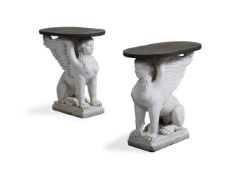 A PAIR OF CARVED WHITE MARBLE AND SLATE SIDE TABLES OF SPHINX BASE FORM, MODERN