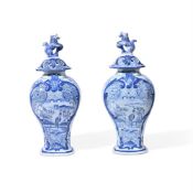 A PAIR OF DUTCH DELFT CHINOISERIE BALUSTER VASES AND COVERS WITH LION FINIALS, CIRCA 1900