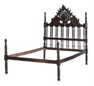 A CARVED HARDWOOD DOUBLE BED IN 19TH CENTURY ANGLO-INDIAN STYLE