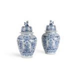 A PAIR OF DUTCH DELFT BLUE AN WHITE CHINOISERIE BALUSTER VASES AND COVERS, CIRCA 1900