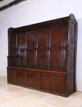 AN OAK FIVE PANEL BACK ‘TAVERN’ SETTLE, LATE 18TH CENTURY