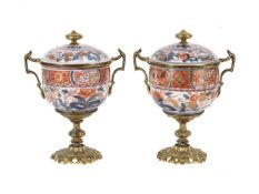 A PAIR OF SAMSON PORCELAIN AND GILT METAL MOUNTED TWO HANDLED PEDESTAL CUPS AND COVERS