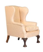 A MAHOGANY AND UPHOLSTERED WING ARMCHAIR IN GEORGE III STYLE