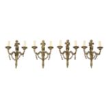 A SET OF FOUR GILT METAL TWIN ARM WALL APPLIQUES IN FRENCH TASTE