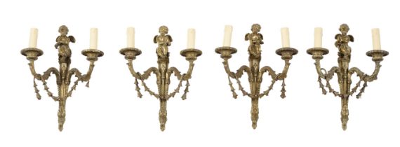 A SET OF FOUR GILT METAL TWIN ARM WALL APPLIQUES IN FRENCH TASTE