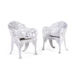 A PAIR OF WHITE PAINTED CAST ALUMINIUM GARDEN ARMCHAIRS IN VICTORIAN, COALBROOKDALE MANNER
