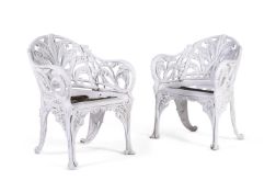 A PAIR OF WHITE PAINTED CAST ALUMINIUM GARDEN ARMCHAIRS IN VICTORIAN, COALBROOKDALE MANNER