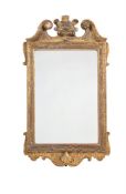 A GEORGE II GILTWOOD AND COMPOSITION WALL MIRROR