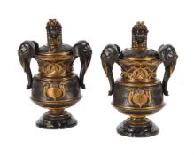 A PAIR OF EGYPTIAN REVIVAL PATINATED BRONZE AND PARCEL GILT URNS AND COVERS