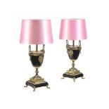 A PAIR OF BLACK SLATE AND GILT METAL MOUNTED TABLE LAMPS
