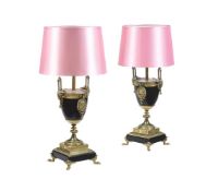 A PAIR OF BLACK SLATE AND GILT METAL MOUNTED TABLE LAMPS