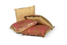 A GROUP OF FOUR CUSHIONS COVERED IN GOLD DAMASK
