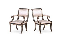 A PAIR OF PAINTED AND PARCEL GILT ARMCHAIRS, IN REGENCY STYLE