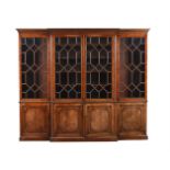 A MAHOGANY BREAK FRONT BOOK CASE IN GEORGE III STYLE