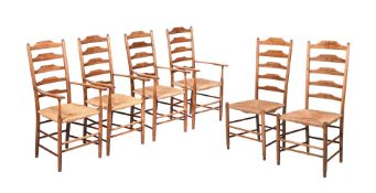 A SET OF FOUR ARTS AND CRAFTS OAK AND RUSH SEATED HIGH BACK ARMCHAIRS