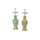 A MATCHED PAIR OF GREEN GLAZED PORCELAIN AND GILTWOOD MOUNTED TABLE LAMPS
