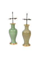 A MATCHED PAIR OF GREEN GLAZED PORCELAIN AND GILTWOOD MOUNTED TABLE LAMPS