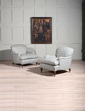 A PAIR OF WALNUT AND UPHOLSTERED 'IVOR' ARMCHAIRS BY HOWARD & SONS LTD.